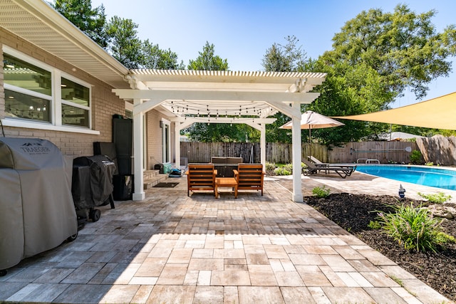 view of patio with a pergola, a fenced in pool, and grilling area