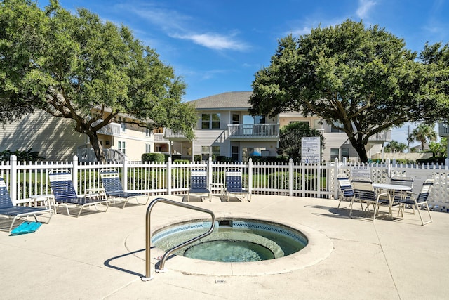 view of pool featuring a hot tub and a patio area