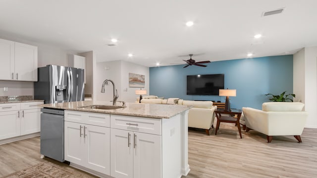 kitchen featuring appliances with stainless steel finishes, white cabinetry, and sink