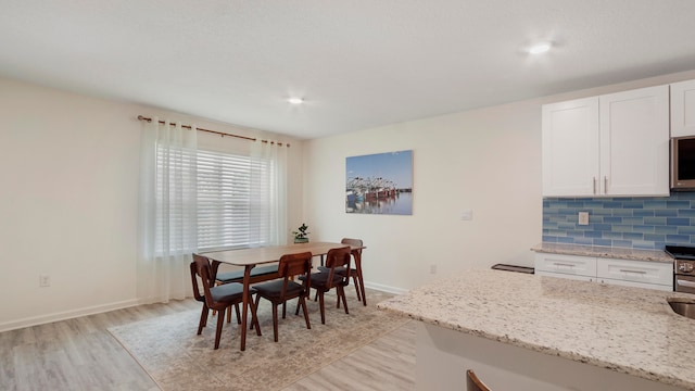 dining room with light hardwood / wood-style flooring