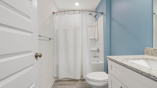 full bathroom with hardwood / wood-style floors, vanity, toilet, and shower / bathtub combination with curtain