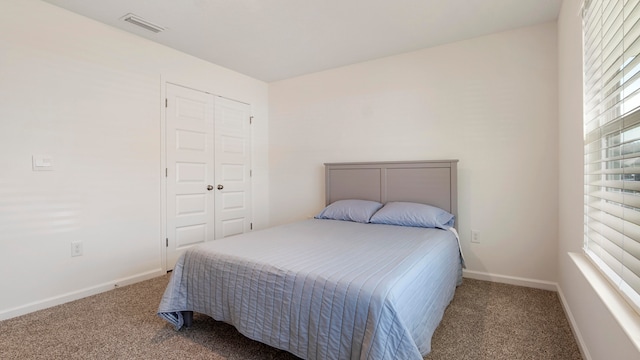 carpeted bedroom featuring a closet