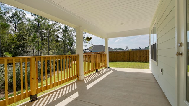 wooden deck featuring a lawn