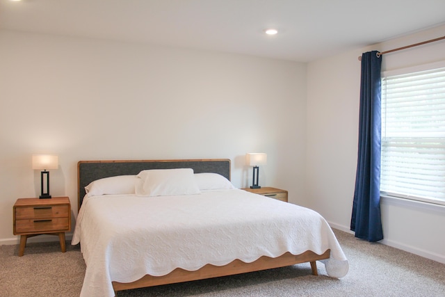 bedroom featuring baseboards, recessed lighting, and light colored carpet