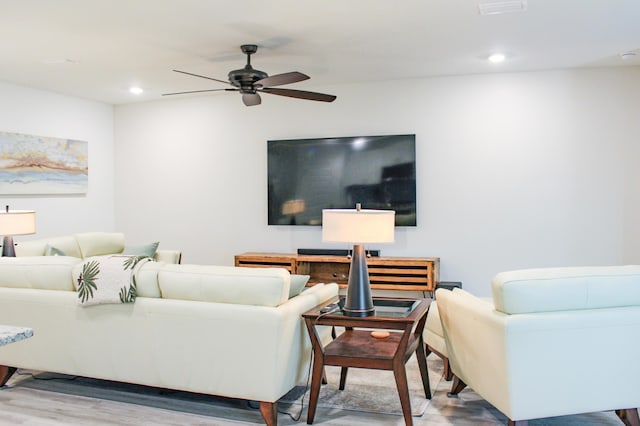 living area featuring wood finished floors, a ceiling fan, and recessed lighting