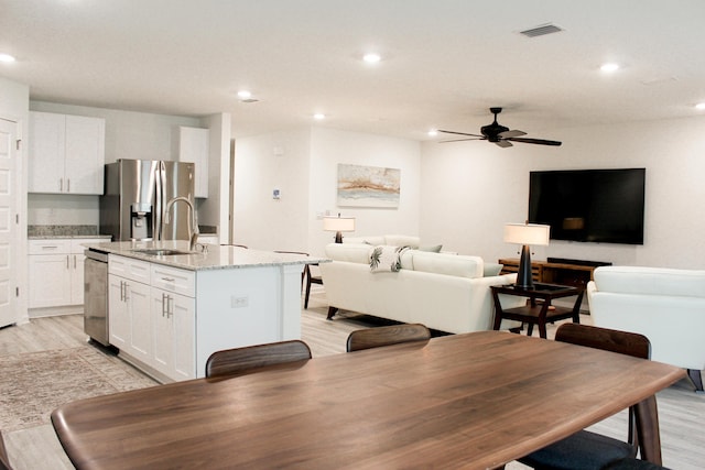 dining area featuring light wood finished floors, visible vents, and recessed lighting