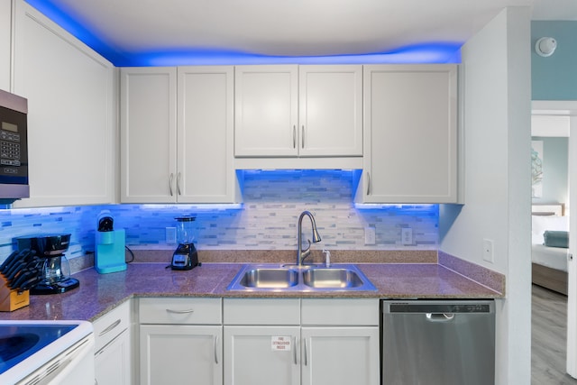 kitchen featuring light hardwood / wood-style flooring, white cabinets, dishwasher, and sink