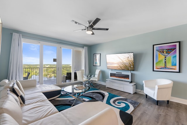 living room featuring wood-type flooring and ceiling fan