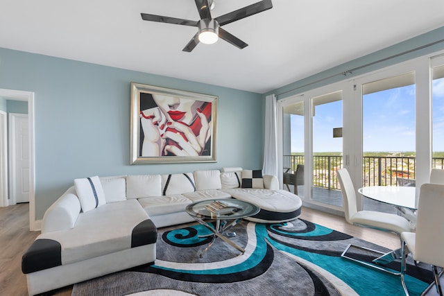 living room featuring hardwood / wood-style floors and ceiling fan