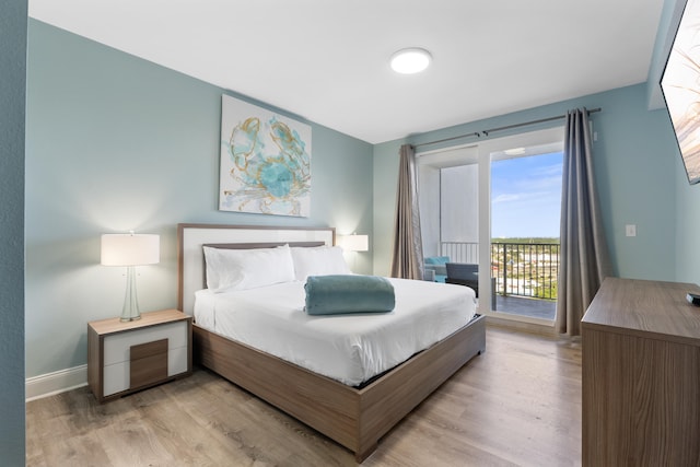 bedroom featuring light hardwood / wood-style flooring and access to outside