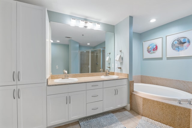 bathroom featuring tile patterned floors, independent shower and bath, and vanity