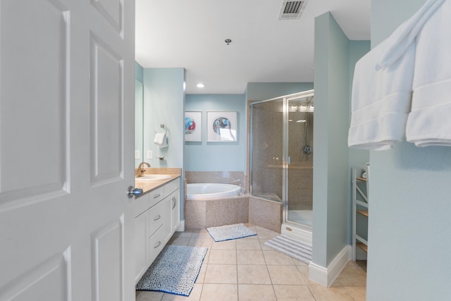 bathroom featuring plus walk in shower, tile patterned flooring, and vanity