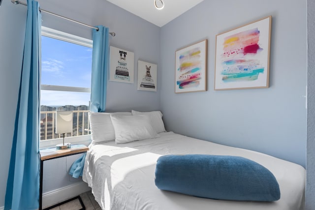 tiled bedroom with multiple windows