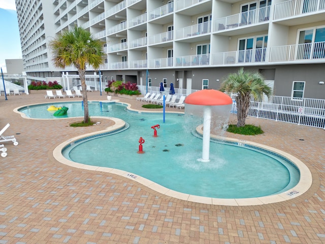 view of pool with a patio and pool water feature