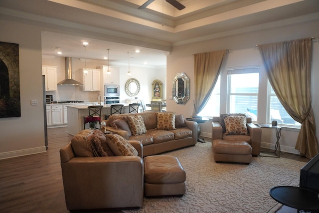 living room with crown molding, sink, ceiling fan, and hardwood / wood-style flooring