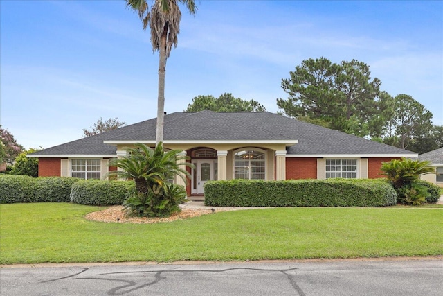 ranch-style home featuring a front lawn