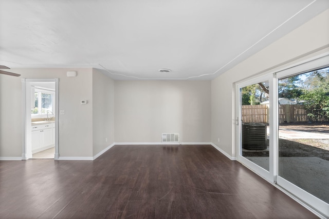 spare room featuring dark wood-type flooring and sink