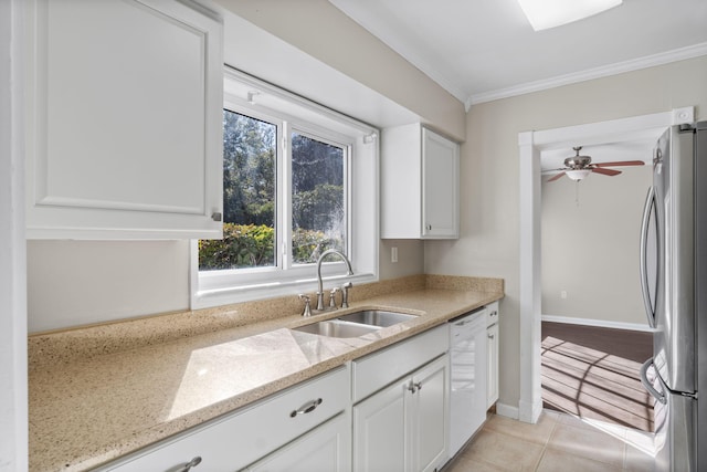 kitchen with white cabinetry, sink, and stainless steel refrigerator