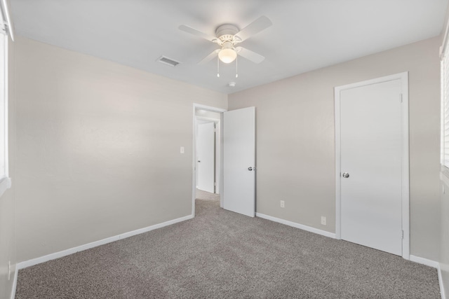 unfurnished bedroom with ceiling fan and carpet flooring