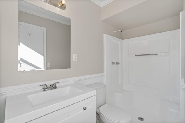 bathroom with vanity, crown molding, toilet, and walk in shower