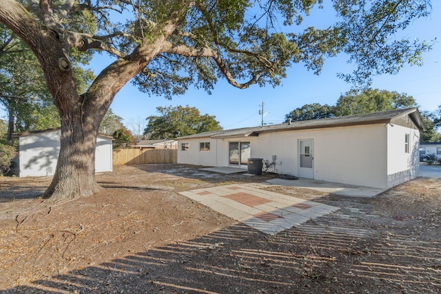 back of house featuring central AC unit and a patio