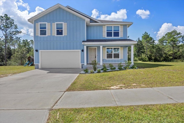 view of front of house featuring a porch, a garage, and a front lawn