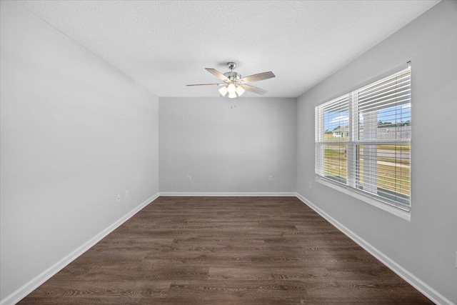 spare room featuring ceiling fan, dark hardwood / wood-style flooring, and a textured ceiling