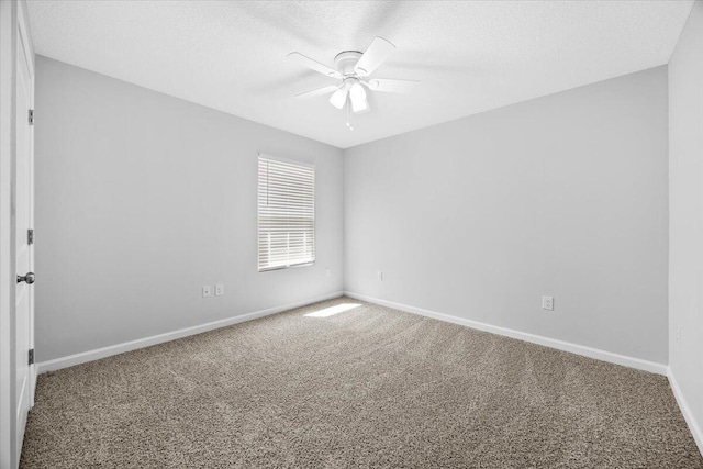 empty room with ceiling fan, carpet floors, and a textured ceiling