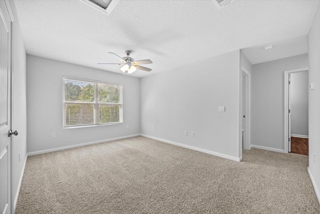 spare room with ceiling fan, carpet floors, and a textured ceiling