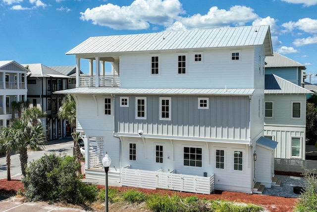 back of property featuring a balcony