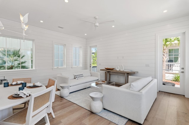 living room featuring visible vents, ceiling fan, light wood-style flooring, and recessed lighting