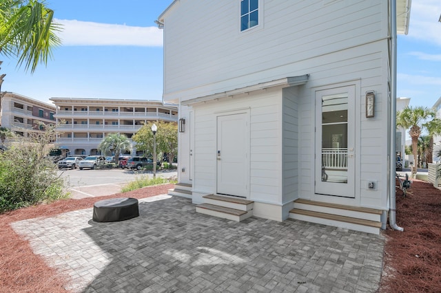 view of exterior entry featuring a patio