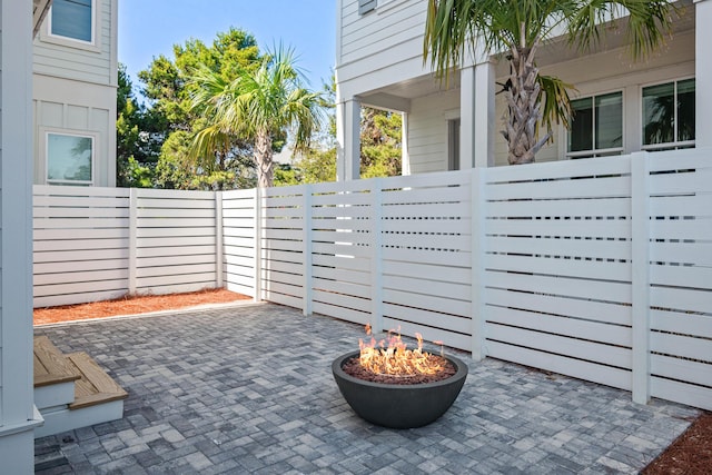 view of patio / terrace with fence and a fire pit