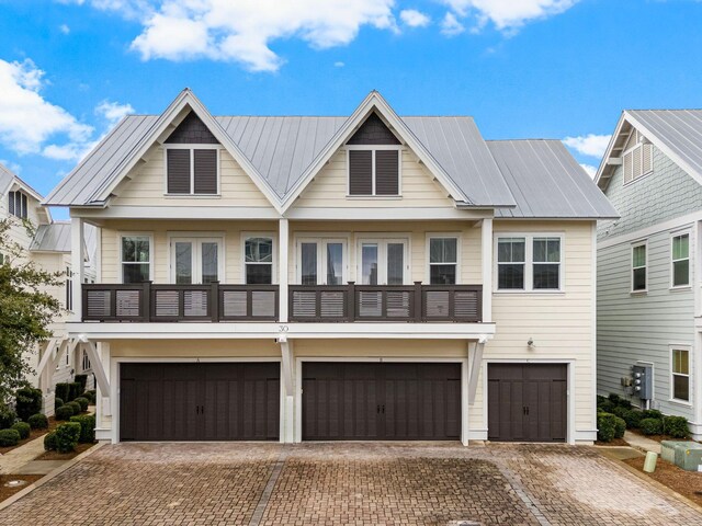 view of front of house with a balcony and a garage