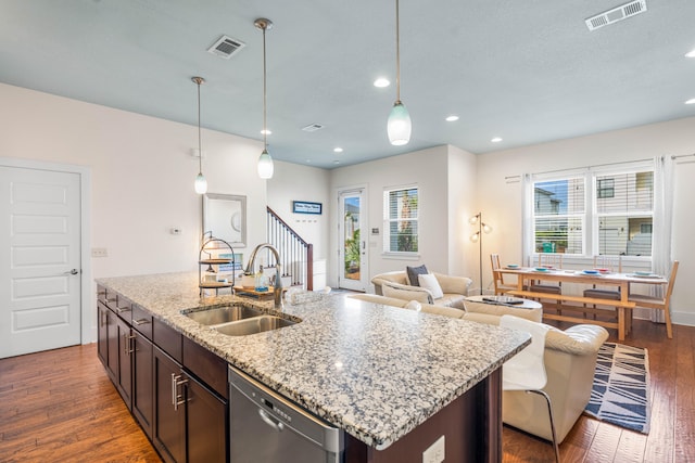 kitchen featuring pendant lighting, sink, dishwasher, and dark hardwood / wood-style floors