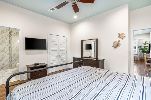 bedroom featuring connected bathroom, a closet, wood-type flooring, and ceiling fan