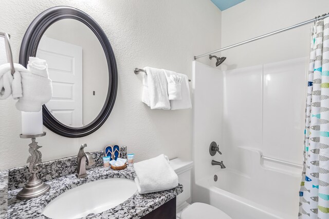 full bathroom featuring vanity, shower / tub combo, and toilet