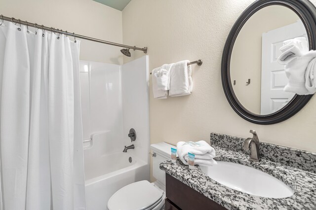 full bathroom with toilet, vanity, and shower / bathtub combination with curtain