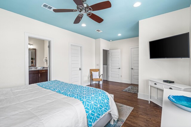 bedroom featuring ensuite bath, dark hardwood / wood-style floors, and ceiling fan