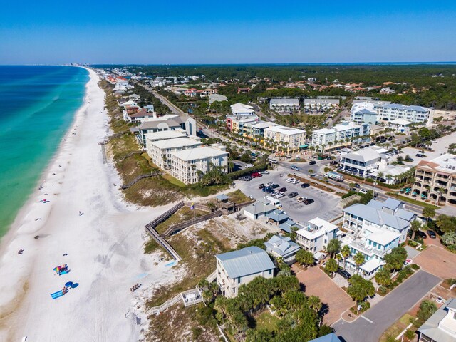 birds eye view of property with a water view and a beach view