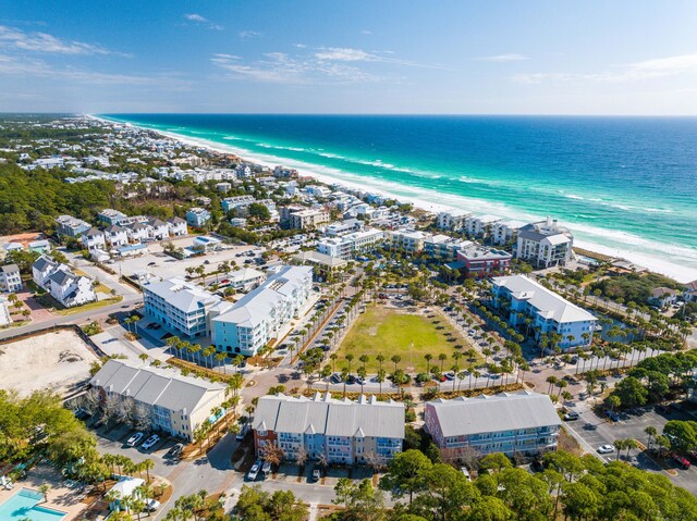 birds eye view of property with a water view and a beach view