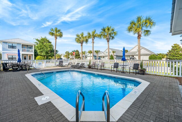 view of swimming pool with a patio