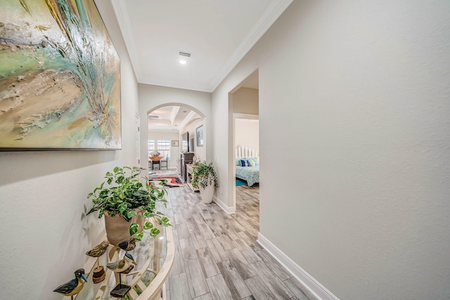 hall featuring crown molding and light hardwood / wood-style floors