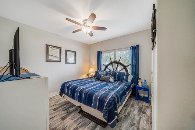 bedroom with hardwood / wood-style floors and ceiling fan