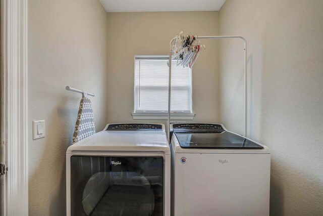 clothes washing area featuring washer and dryer