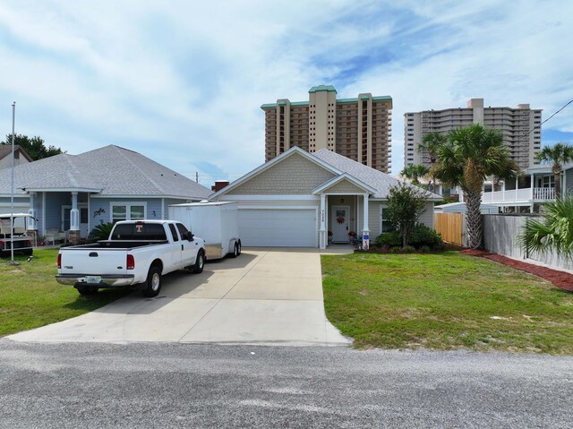 view of front of home featuring a front lawn and a garage