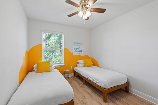 bedroom featuring light wood-type flooring and ceiling fan