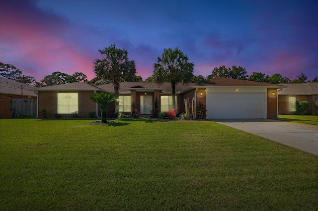 single story home with a yard and a garage