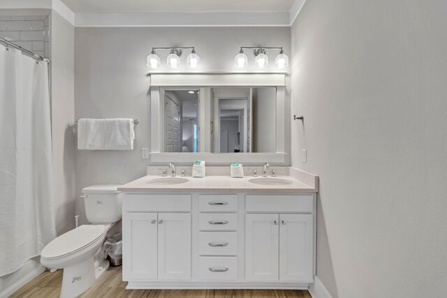 bathroom featuring vanity, toilet, a shower with curtain, crown molding, and hardwood / wood-style floors