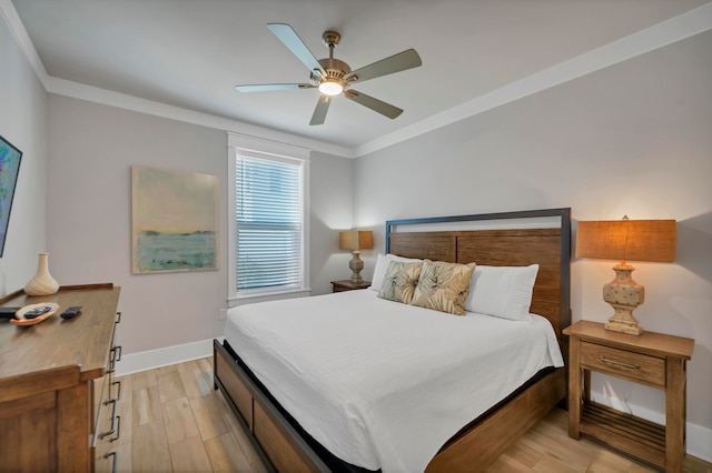 bedroom featuring light hardwood / wood-style floors, ornamental molding, and ceiling fan